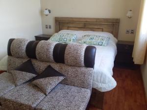 a bed that has some pillows on it at Hostal Nichkito in Uyuni