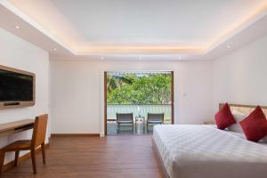 a bedroom with a bed and a table and chairs at Downtown Villas in Seminyak