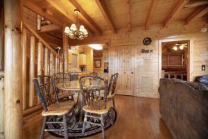 a dining room with a table and chairs in a cabin at Livin High in Sevierville