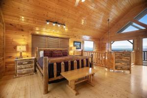 a bedroom in a log cabin with a bed and a table at Livin High in Sevierville