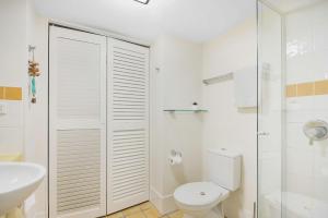 a white bathroom with a toilet and a sink at ALEXANDRA BEACH RESORT-ALEX412 in Alexandra Headland