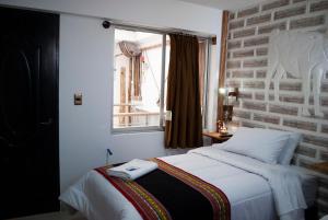 Postel nebo postele na pokoji v ubytování Hotel Sal Andina