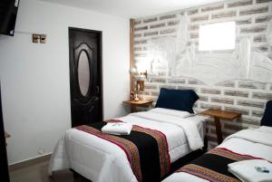 Postel nebo postele na pokoji v ubytování Hotel Sal Andina