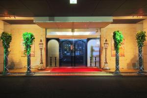 a front door of a building with a red carpet at Hotel GIG (Adult Only) in Kawagoe