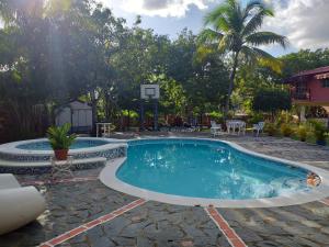 a pool with a basketball hoop in a yard at Army Village RD in La Piña