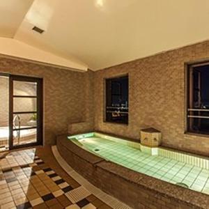 a large swimming pool in a room at Kitabiwako Hotel Grazie in Nagahama