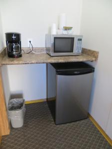 a microwave sitting on a counter in a room at Sundown Motel in Watrous