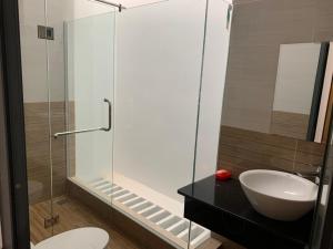 a bathroom with a sink and a glass shower at Hotel Hiệp Thành in Tuy Hoa +37 photos