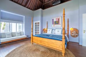 a bedroom with a wooden bed with a blue mattress at Ulu Cliffhouse in Uluwatu