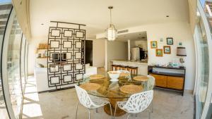 cocina y comedor con mesa y sillas en Elements Penthouse 5 condo, en Playa del Carmen
