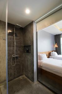 a hotel room with a shower and a bed at Inthira Vangvieng in Vang Vieng