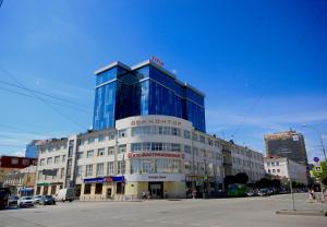 a large building with glass windows on a city street at RADIUS Central House in Yekaterinburg