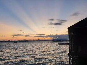a sunset over a large body of water at Sea Star Resort Semporna in Semporna