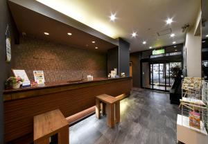a restaurant with a counter and a bench in front at HOTEL ROUTE-INN Kamiyamada Onsen in Chikuma +24 photos