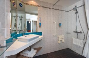 a bathroom with a sink and a shower at Holiday Inn Express Edinburgh - Leith Waterfront by IHG in Edinburgh