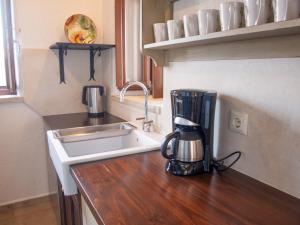 a kitchen counter with a blender next to a sink at Grand View Kimon in Mythimna