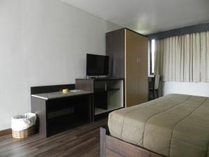 a bedroom with a bed and a flat screen tv at City Residence Rama 6 in Bangkok