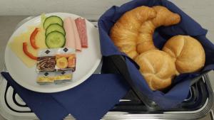 a plate of bread and pastries on a tray at Blue River Side in Blaustein