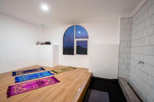 two mats on the floor in a room with a window at Bobopod Pancoran, Jakarta in Jakarta +21 photos