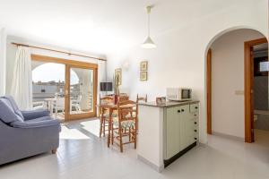 sala de estar con cocina y mesa con microondas en Lladoner 2G, en Puerto Pollensa