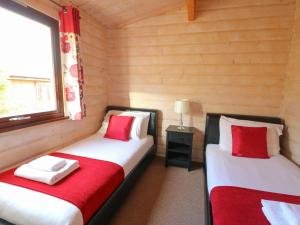two twin beds in a room with a window at Mountain View in Rhayader