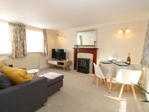 a living room with a couch and a table at The Waiting Room in Norwich