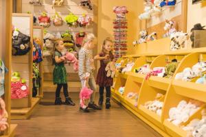 a group of children standing in a store with stuffed animals at Vakantiepark Slagharen in Slagharen