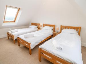 two twin beds in a room with a window at Auckland Cottage in Bishop Auckland