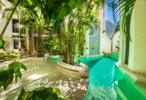 a swimming pool in a house with trees in it at Royal Palms 10 condo in Playa del Carmen