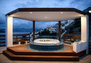 a hot tub on the deck of a house at Vasilis Studios in Myrties