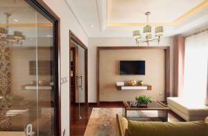 a living room with a couch and a glass door at JB Serviced Apartment in Hanoi
