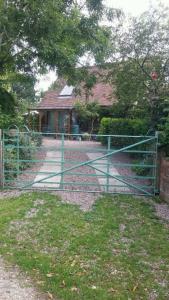 a gate in front of a house with a house at Parrs cottage in Wollaston