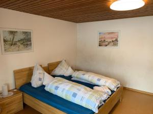 a bedroom with a bed with two pillows on it at Landhaus Alpenstern in Riezlern