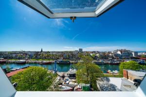 a view of a harbor with boats in the water at WIROtel Warnemünde in Warnemünde