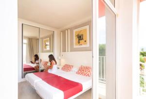 two women in a hotel room with two beds at Ibersol Antemare - Adults Only in Sitges