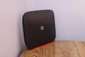 a black clock sitting on top of a wooden table at Corffe House and Holiday Cottages in Barnstaple