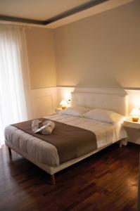 a bedroom with a large white bed with two lamps at MAMO al Museo in Naples