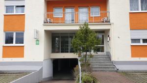 a building with a staircase and a balcony at Hotel Arheilger Hof in Darmstadt