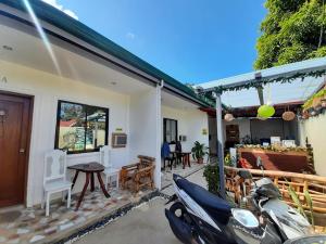 a house with a motorcycle parked outside of it at Little Haven at Lio in El Nido