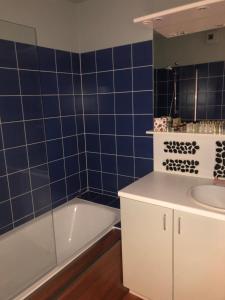 a blue tiled bathroom with a tub and a sink at Les Dunes Du Golf First Line Sea View App Block B 1-3 in Wimereux +63 photos