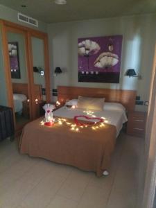 Un dormitorio con una cama con luces. en Hostal Playa Mazagon (El Remo), en Mazagón
