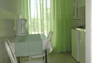 a kitchen with a table with a coffee maker on it at STUDIO MIMI CENTER OF TOWN KRK CROATIA in Krk
