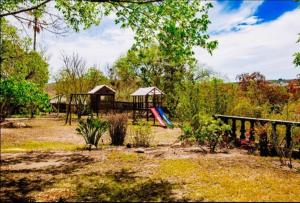 a playground with a slide and a play structure at BougainVilla Guest House in King Williamʼs Town