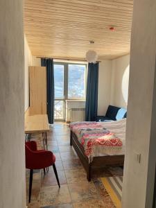 a bedroom with a bed and a desk and a window at M.A.K.home in Vyshka +73 photos