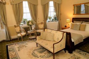 a bedroom with a bed and a couch and a chair at The Bulkeley Hotel in Beaumaris +58 photos