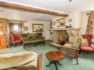 a living room filled with furniture and a fireplace at Rose Hips Barn in Chorley