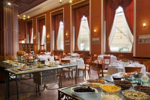 a dining room with tables filled with food at Ramada by Wyndham Plovdiv Trimontium in Plovdiv