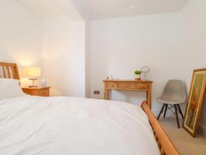 a bedroom with a bed and a desk and a chair at 2A The Mews in Havant