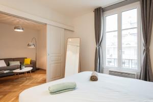 a bedroom with a bed and a large window at DIFY Cosy - Centre Ville in Lyon