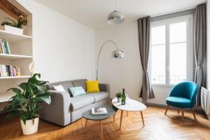 a living room with a couch and a table at DIFY Cosy - Centre Ville in Lyon